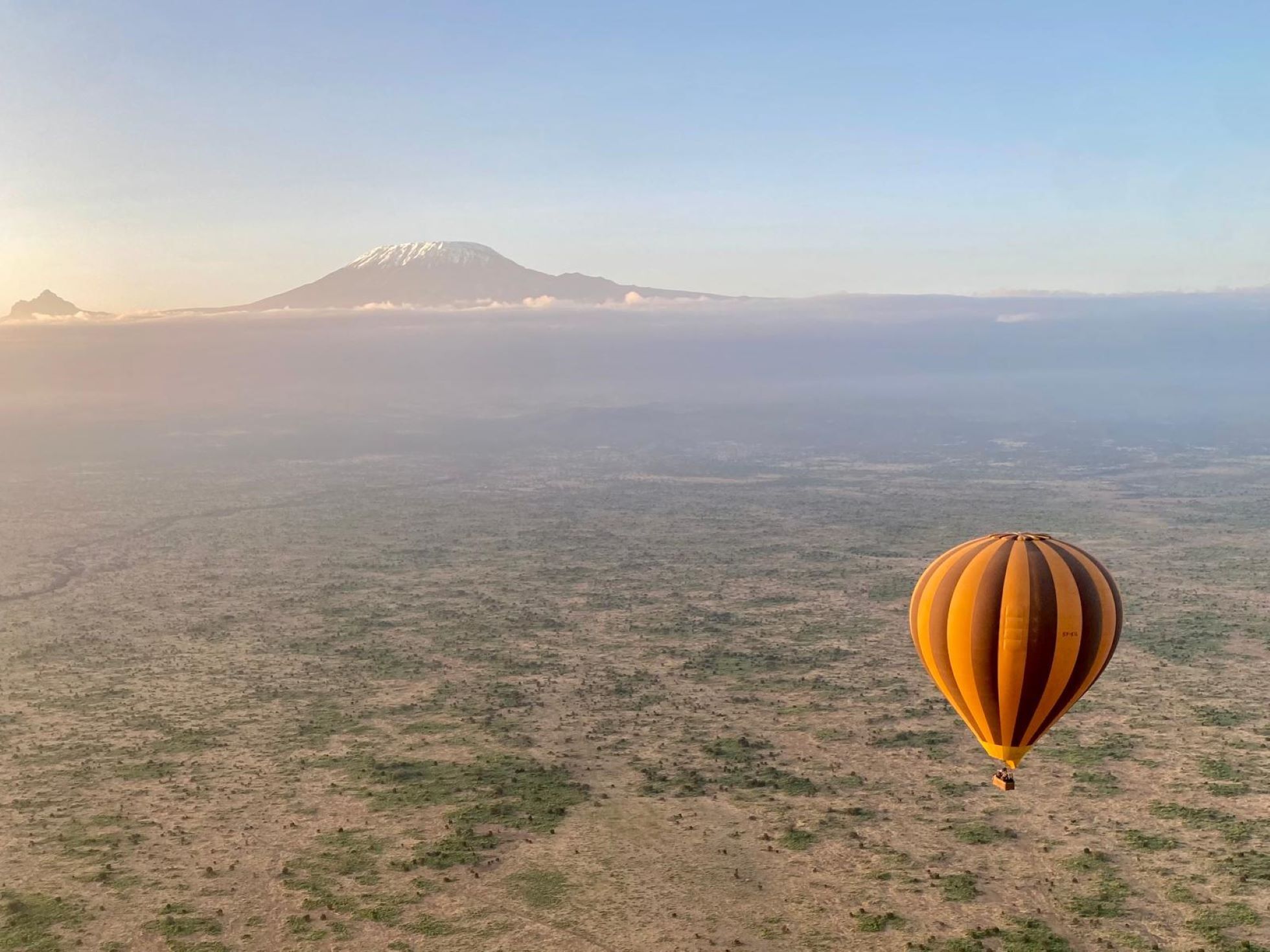 Hot air balloon over Amboseli National Park with mountain in the background