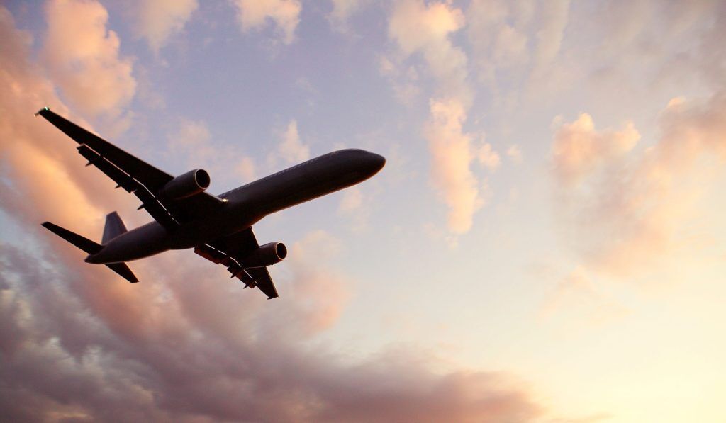 Flying plane from underneath with clouds