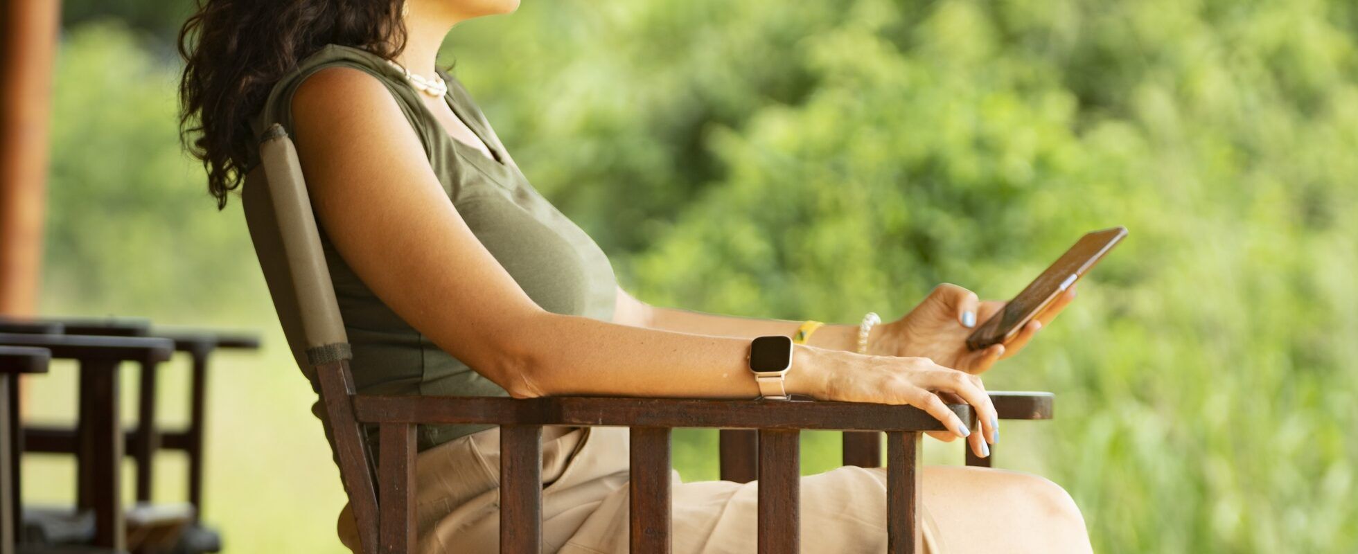 Woman sitting on a chair with a phone in her hand