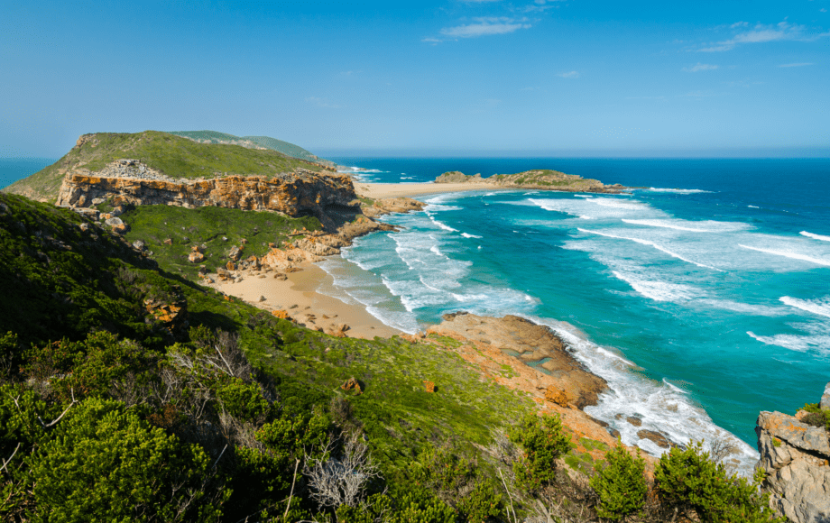 Scenic coastal landscape with rugged cliffs, sandy beaches and turquoise ocean in South Africa.